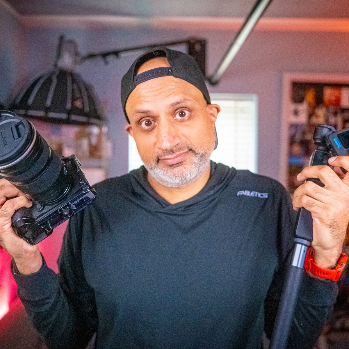 Sunjay in the studio holding a camera and microphone